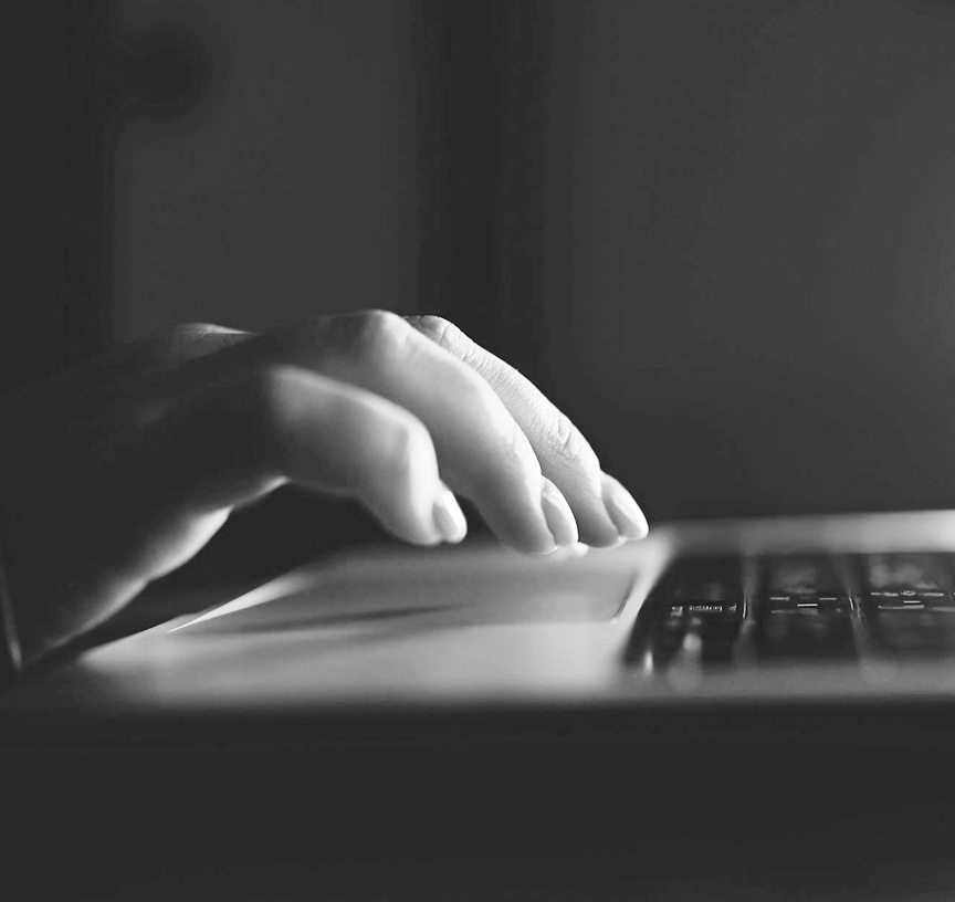 Hand on a laptop's keyboard